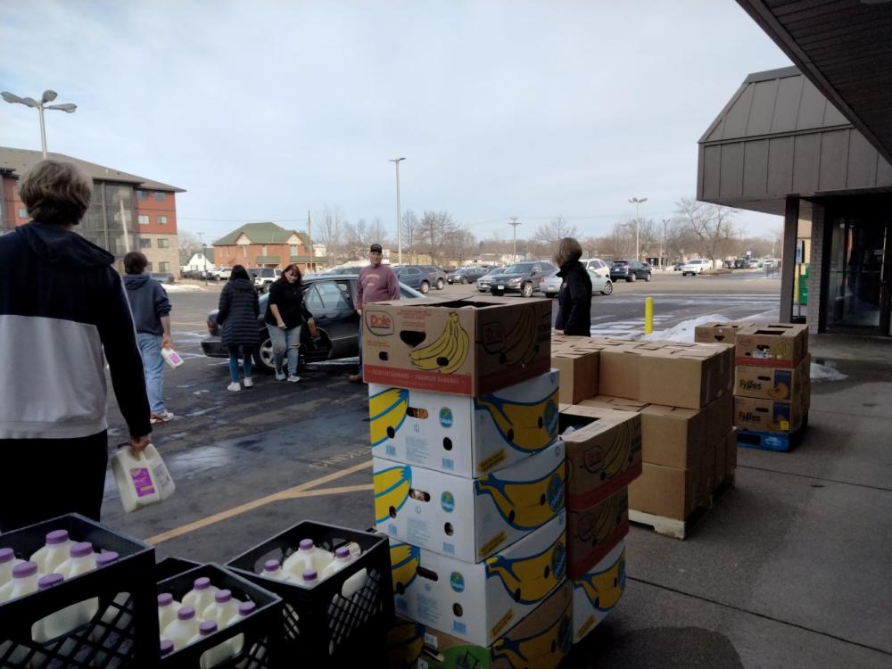 volunteers load food into the cars of community members at Monticello Help Center’s curbside pick-up program