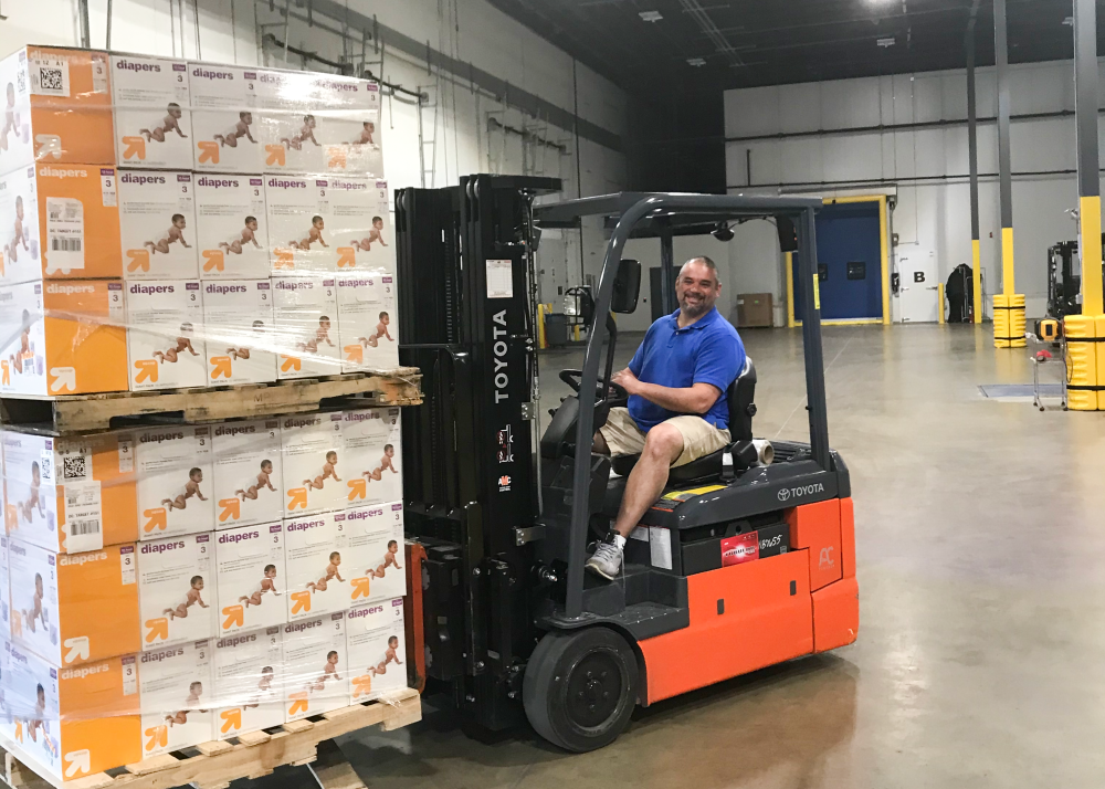 Omar Jarrar on a fork lift in warehouse