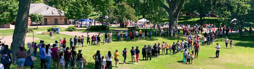 Line in park at food distribution