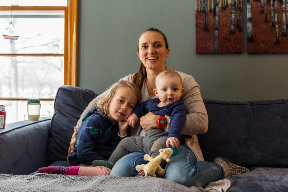 Mother with her two children sitting on a couch