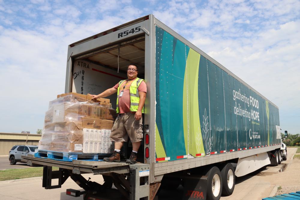 Second Harvest Heartland Delivery Driver smiling on the truck