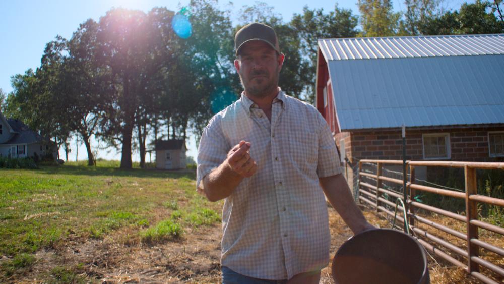 Farmer snapping in the farmyard