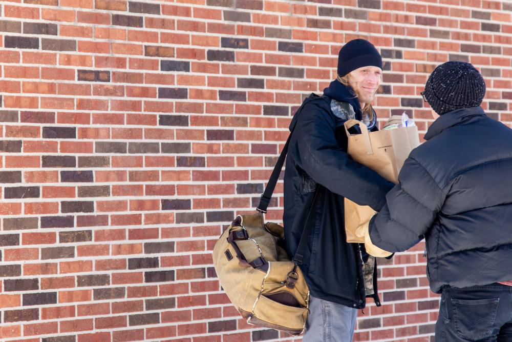 Man receives a bag of groceries