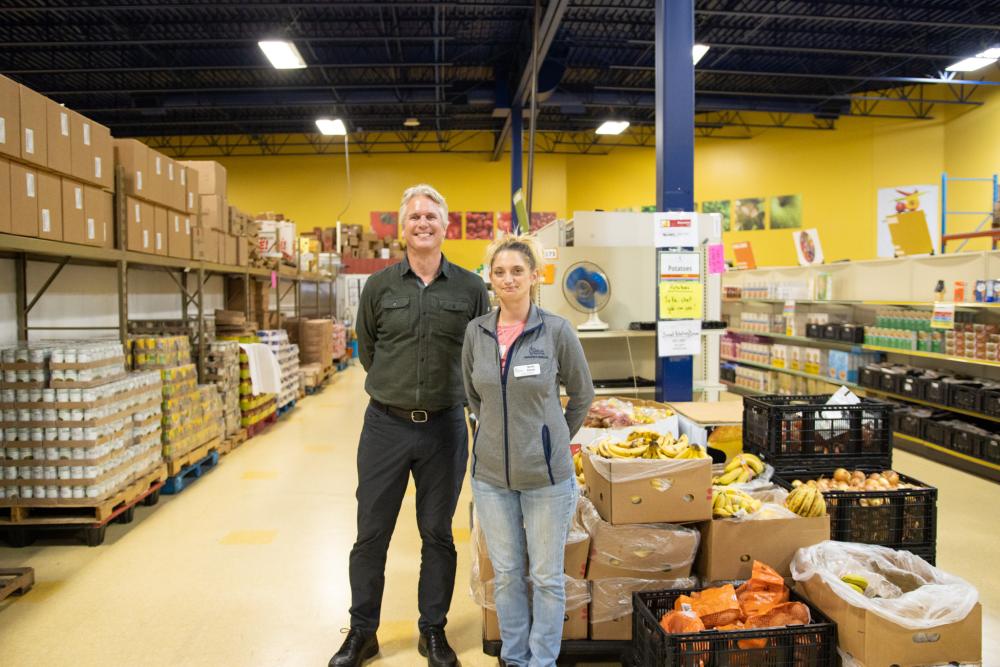 Two people standing at Food Shelf