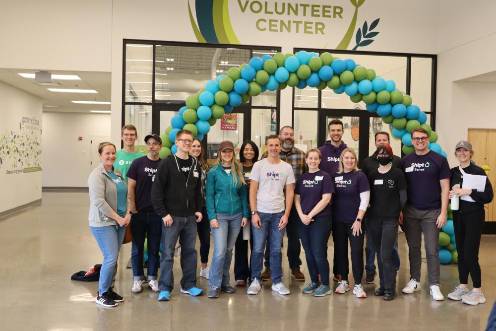 A group of volunteers pose outside of the volunteer center