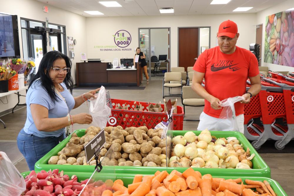 A couple shops for produce