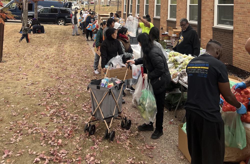 A line of people at a produce distribution