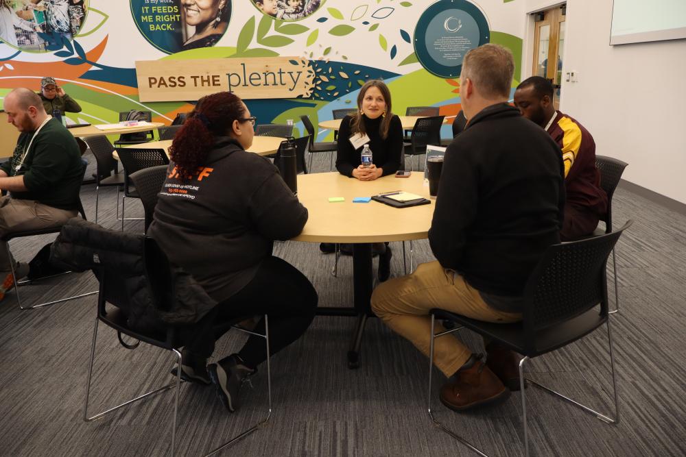 Partners exchange ideas around a conference table