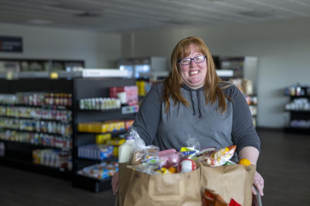 An adult shopping for groceries at a food shelf