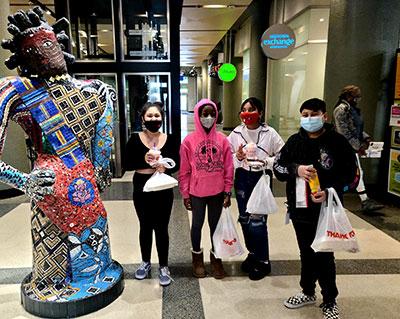 Kids with bags of food at Midtown Global Market