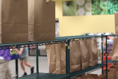 Paper grocery bags on a wire shelf