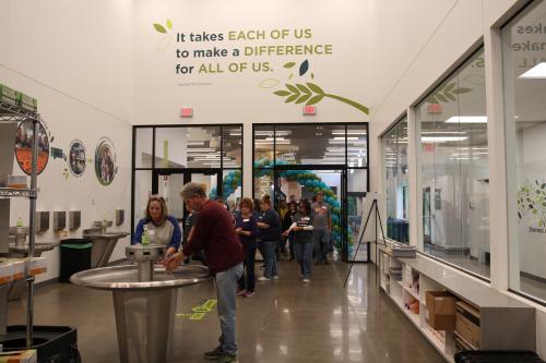 A group of volunteers wash their hands before entering a packing center