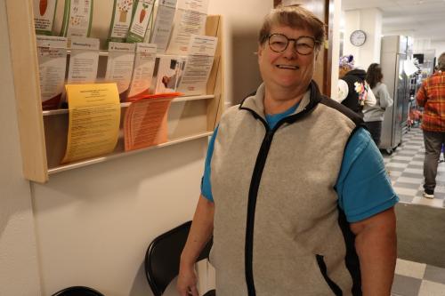 A volunteer poses at a food shelf