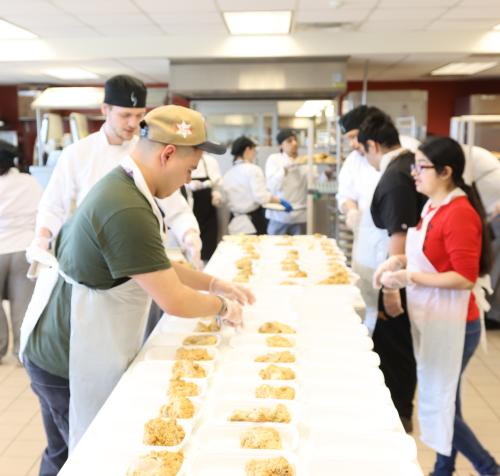 A group of chefs plate Kitchen Coalition meals