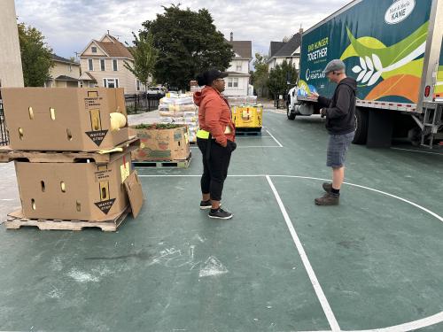 Two people outside of a Second Harvest Heartland food truck