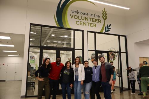 People pose outside of our volunteer center