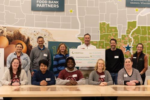 A check presentation at a food bank